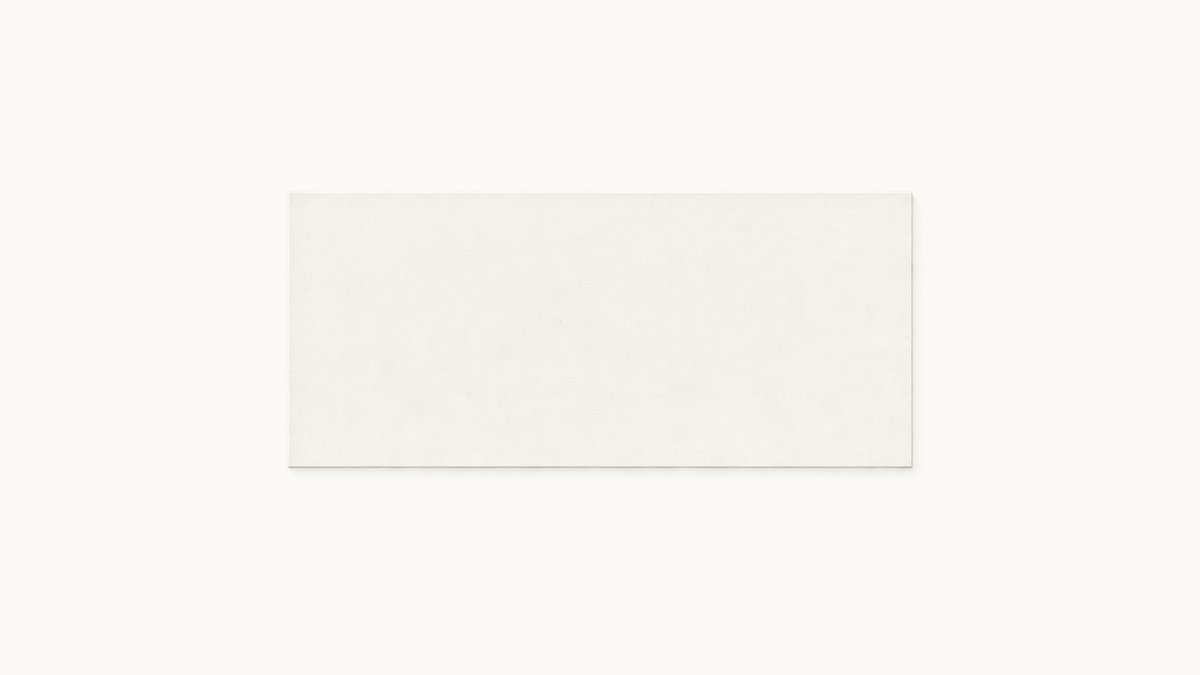 A plain flat nameplate sign mounted on a wall painted the exact same color, nearly disappearing into it, only a faint seam outline visible